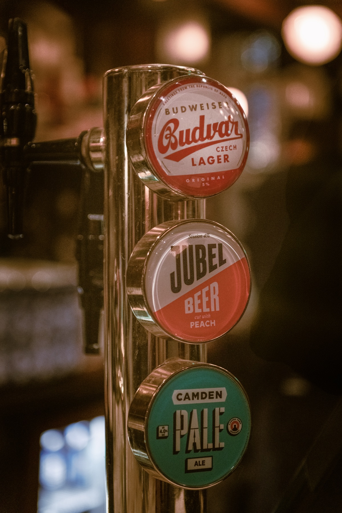Beer taps glowing in the warm light of a pub